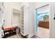 Walk-in closet with custom shelving next to the doorway of a bathroom with blue walls at 3233 Belcherry Loop, The Villages, FL 32163