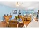 Cozy dining area with rattan chairs, a glass-top table, and a view into the living room at 3233 Belcherry Loop, The Villages, FL 32163