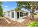 View of the exterior of the house features a patio and well maintained yard at 3233 Belcherry Loop, The Villages, FL 32163