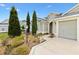 A charming home front yard, adorned with well-manicured greenery and lush plantings at 3233 Belcherry Loop, The Villages, FL 32163