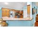 Bright kitchen features a breakfast bar, granite countertops and modern stainless steel appliances at 3233 Belcherry Loop, The Villages, FL 32163