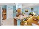 Bright kitchen features a breakfast bar, granite countertops and view to the living room at 3233 Belcherry Loop, The Villages, FL 32163