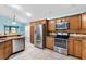 Modern kitchen features stainless steel appliances, granite countertops and lots of wooden cabinets at 3233 Belcherry Loop, The Villages, FL 32163