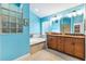 Well-lit bathroom featuring double sinks, soaking tub and glass block window at 3233 Belcherry Loop, The Villages, FL 32163