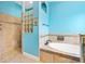 Stylish bathroom featuring soaking tub, tiled shower and glass block window at 3233 Belcherry Loop, The Villages, FL 32163
