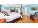 Spacious main bedroom featuring wood floors and adjacent ensuite at 3233 Belcherry Loop, The Villages, FL 32163