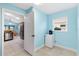 Mud room with blue walls, tile flooring, and doorway to the kitchen at 3233 Belcherry Loop, The Villages, FL 32163