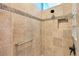 The shower features neutral tile, decorative accent tile, a handheld shower, and a built-in niche at 3233 Belcherry Loop, The Villages, FL 32163