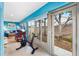 Bright sunroom provides access to the yard and features exercise equipment at 3233 Belcherry Loop, The Villages, FL 32163