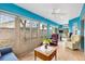 Bright sunroom features large windows, comfortable seating, and plenty of natural light at 3233 Belcherry Loop, The Villages, FL 32163