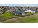 Aerial view of a home with a screened-in patio overlooking a golf course at 3234 Berkeley Ln, The Villages, FL 32162