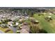 Aerial view of a residential area bordering a golf course at 3234 Berkeley Ln, The Villages, FL 32162