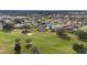 Overhead view of a golf course, clubhouse, and the surrounding residential neighborhood at 3234 Berkeley Ln, The Villages, FL 32162