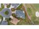 An aerial view showing property lines of home in a golf community, landscaped yard, driveway, and close proximity to the green at 3234 Berkeley Ln, The Villages, FL 32162