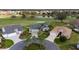 Aerial view of a landscaped home with a circular driveway, close to the golf course at 3234 Berkeley Ln, The Villages, FL 32162