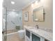 Bathroom featuring a glass shower enclosure, tile shower, and modern vanity with stone countertops at 3234 Berkeley Ln, The Villages, FL 32162
