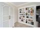 Built-in bookshelves flanking a doorway, next to a decorative linen closet with double doors at 3234 Berkeley Ln, The Villages, FL 32162