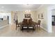 Formal dining room with an elegant wooden table and views into the kitchen at 3234 Berkeley Ln, The Villages, FL 32162