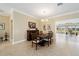 Formal dining room with an elegant chandelier and views of the outdoor scenery at 3234 Berkeley Ln, The Villages, FL 32162