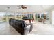 Expansive game room with large windows offering scenic views, a billiard table, tile flooring, and comfortable seating at 3234 Berkeley Ln, The Villages, FL 32162