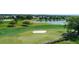 Scenic golf course view featuring lush green fairways, a tranquil lake, and well-maintained sand traps at 3234 Berkeley Ln, The Villages, FL 32162