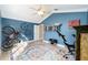 Home gym featuring vibrant blue walls, exercise equipment, and a ceiling fan at 3234 Berkeley Ln, The Villages, FL 32162