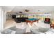 Open-concept entertainment space featuring a billiard table, cozy seating, tile flooring, and large windows with outdoor views at 3234 Berkeley Ln, The Villages, FL 32162