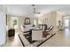 Living room featuring tile floors, a ceiling fan, and a comfortable white sofa, creating a cozy ambiance at 3234 Berkeley Ln, The Villages, FL 32162