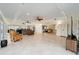 Spacious living area showcasing tile floors, recessed lights, a ceiling fan, and seamless access to adjoining rooms at 3234 Berkeley Ln, The Villages, FL 32162