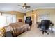 Spacious bedroom boasts a ceiling fan, tile floors, and includes a functional desk area at 3234 Berkeley Ln, The Villages, FL 32162