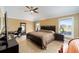Bedroom features a ceiling fan, natural light, a spacious layout, and tile floors at 3234 Berkeley Ln, The Villages, FL 32162