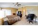 Bedroom features a ceiling fan, tile floors, and includes a functional desk area at 3234 Berkeley Ln, The Villages, FL 32162