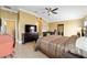 Bedroom with a ceiling fan, desk, and tiled flooring with plenty of space to relax at 3234 Berkeley Ln, The Villages, FL 32162