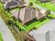 Aerial view of the property showcasing a well-manicured lawn, lush landscaping, and a serene backyard at 3654 Enterprise Dr, The Villages, FL 32163