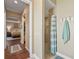 Bathroom hallway view featuring a walk-in shower and access to the main bedroom and closet at 3654 Enterprise Dr, The Villages, FL 32163