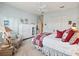Bedroom showcasing a closet, and a relaxing sitting area next to a window at 3654 Enterprise Dr, The Villages, FL 32163