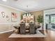 The dining room has hardwood floors, decorative lighting, and seating for six at 3654 Enterprise Dr, The Villages, FL 32163