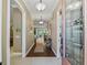 Bright entryway featuring a decorative glass door, hardwood floors, and stylish console table at 3654 Enterprise Dr, The Villages, FL 32163