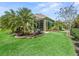 A well manicured lawn highlights this home's screened-in porch and covered outdoor living area at 3654 Enterprise Dr, The Villages, FL 32163