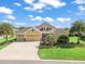Charming home boasts a lush lawn, mature palms, and a welcoming three-car garage at 3654 Enterprise Dr, The Villages, FL 32163