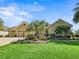 Well-maintained home with a manicured lawn and beautiful landscaping, including mature palm trees at 3654 Enterprise Dr, The Villages, FL 32163