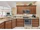 Well-equipped kitchen featuring granite countertops, stainless steel appliances, and custom cabinetry at 3654 Enterprise Dr, The Villages, FL 32163