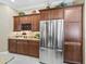 Kitchen area showcasing stainless steel refrigerator, wine rack, and granite countertops at 3654 Enterprise Dr, The Villages, FL 32163