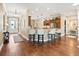 Spacious kitchen featuring granite countertops, stainless steel appliances, breakfast bar, and hardwood floors at 3654 Enterprise Dr, The Villages, FL 32163