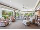Bright and airy living room with floor-to-ceiling windows and comfortable seating arrangements at 3654 Enterprise Dr, The Villages, FL 32163