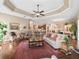 Open-concept living area with kitchen, dining and living room with hardwood floors and neutral color palette at 3654 Enterprise Dr, The Villages, FL 32163