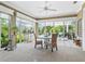 Bright living area featuring dining set, decor, and wall of windows providing lots of natural light at 3654 Enterprise Dr, The Villages, FL 32163