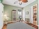 Home office with hard wood floors and a decorative ceiling fan, next to a bathroom at 3654 Enterprise Dr, The Villages, FL 32163