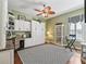 A well-lit office with a built-in desk, storage, and a decorative ceiling fan, perfect for working from home at 3654 Enterprise Dr, The Villages, FL 32163