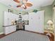 Lovely home office featuring built in shelving, hard wood floors and a decorative ceiling fan at 3654 Enterprise Dr, The Villages, FL 32163